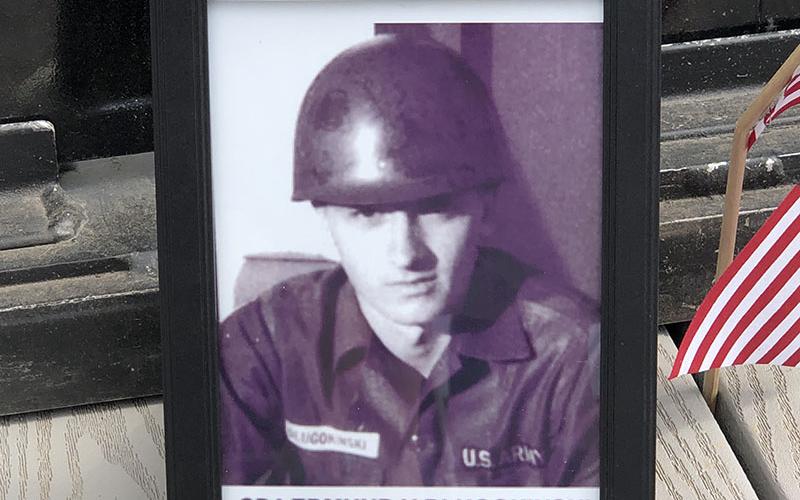 Mark Dlugokinski told the story of his uncle Edmund who was killed tending to a wounded comrade. Mark placed this picture at the base of the panel on the Vietnam Traveling Wall Memorial containing Edmund’s name.