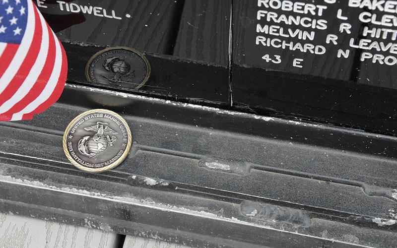 A photo of Jewell Robert Green and a United States Marine Corps coin were at the base of the Vietnam Memorial Traveling Wall Sunday, no doubt placed quietly by those who remembered sacrifices.