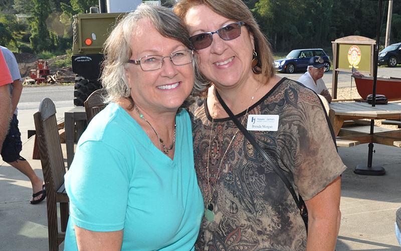 Debbie Monck and Brenda Morgan catch up during the Chamber of Commerce’s Business After Hours and Blues &amp; BBQ Festival kickoff party at Grumpy Old Men Brewing.