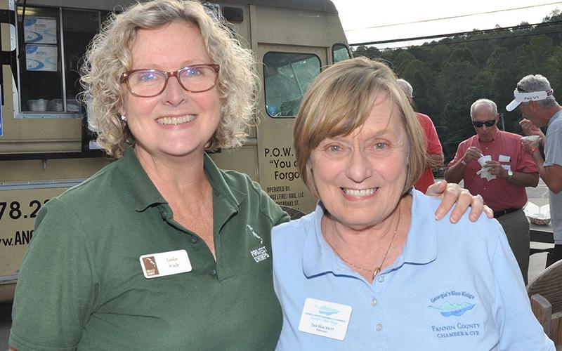 Project Chimps Communications Manager Leslie Wade stands with chamber President Jan Hackett at the Chamber of Commerce’s Business After Hours and the Blue Ridge Lodging Association’s Blues &amp; BBQ Festival kickoff party at Grumpy Old Men Brewing.