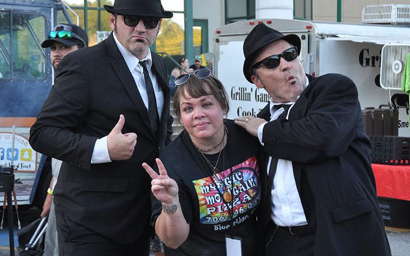 The Blues Brothers crashed the Blue Ridge Blues &amp; BBQ Festival, September 21. Shown carousing with them is Brannan Mathis of Mystic Mountain Pizza.