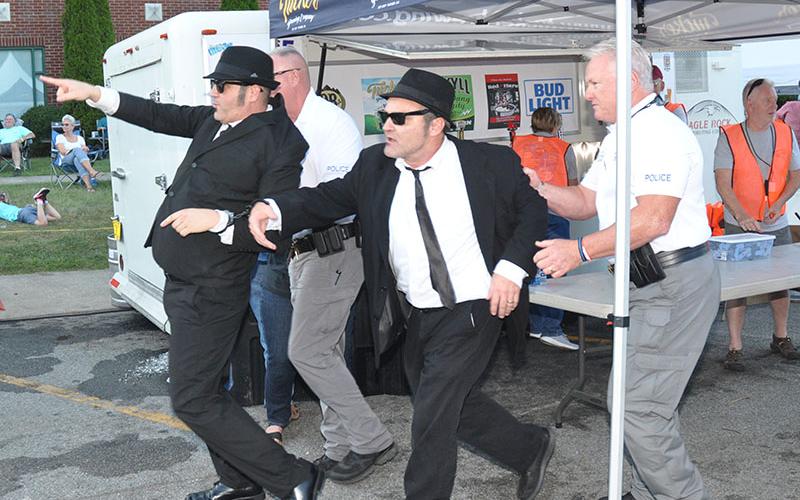 After being arrested, Blue Ridge Police Chief Johnny Scearce and Officer Thomas Davis led the unruly men to the stage to be judged by Chief Magistrate Judge Brian Jones.