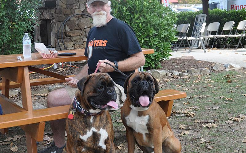 Brian Peay snacks on barbeque brisket as European Boxers, Hondo and Modi watch all the spectators who came to see the Builders Showcase, October 5.