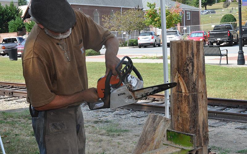 Mike Duke, chainsaw carver with Karvers Korner, carves a wizard in a piece of wood during the Builders Showcase sponsored by the Georgia High Country Builders Association, October 5.