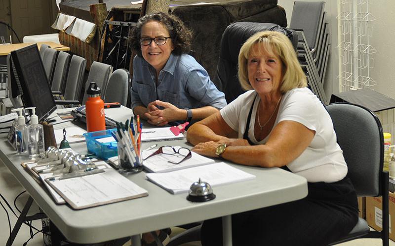 Fannin County Family Connection food pantry volunteers Kathy Corey, left, and Denise Hyatt help folks from the community who need food to nurish their families. October 1 was the first day the food pantry was open at the new location at 501 Industrial Park Rd.