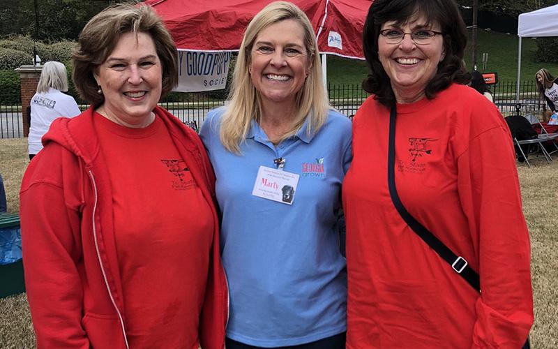 Georgia’s First Lady Marty Kemp, center, organized a pet adoption event at the Governor’s Mansion this past March. Tri State Pet Rescue volunteers Victoria McLaughlin, left, and Jan Eaton stand with her in support.