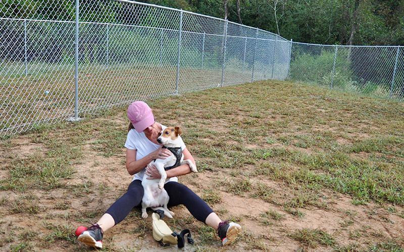 Fannin County Animal Control volunteer Debbie Williams spends time with one of the facility’s residents,“Rocco,” in Animal Control’s recently completed dog run.