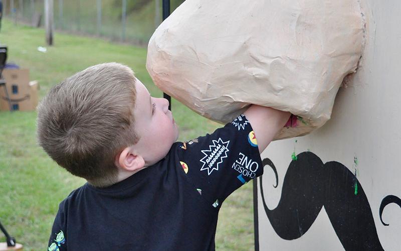 Logan Setser reached into a gigantic nose in order to retrieve a treat during Fannin County elementary schools’ Fall Festival.