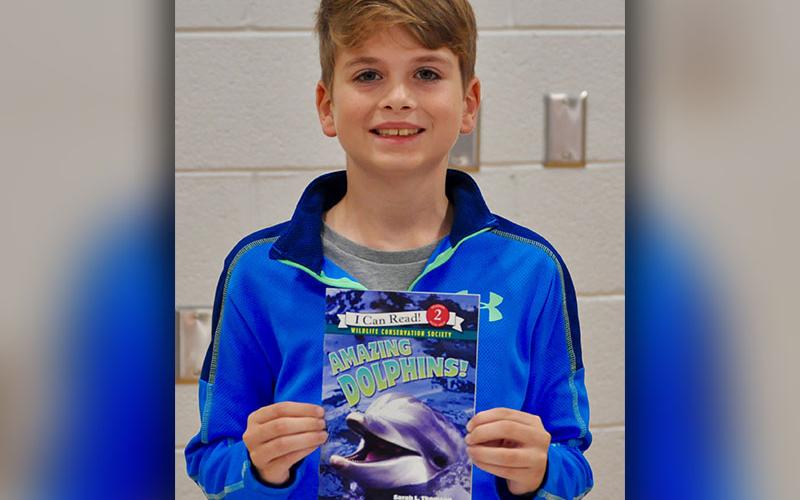 East Fannin Elementary School student Cash Lambert won a book while participating in the book walk at the school’s literacy night.