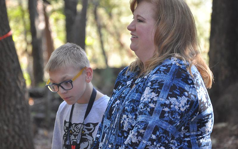 East Fannin Elementary School student Jonathan Jones and his mother, Dori Jones, enjoyed story time in the school’s outdoor classroom during a camping themed literacy night Wednesday, October 16.