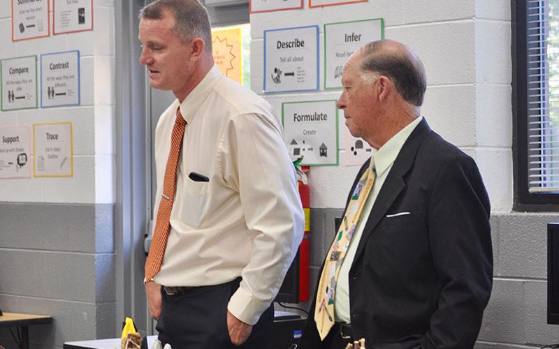 Fannin County Board of Education members Chad Galloway, left, and Bobby Bearden walk through the STEM classroom at Fannin County Middle School to view student projects during the board retreat Thursday, October 10.