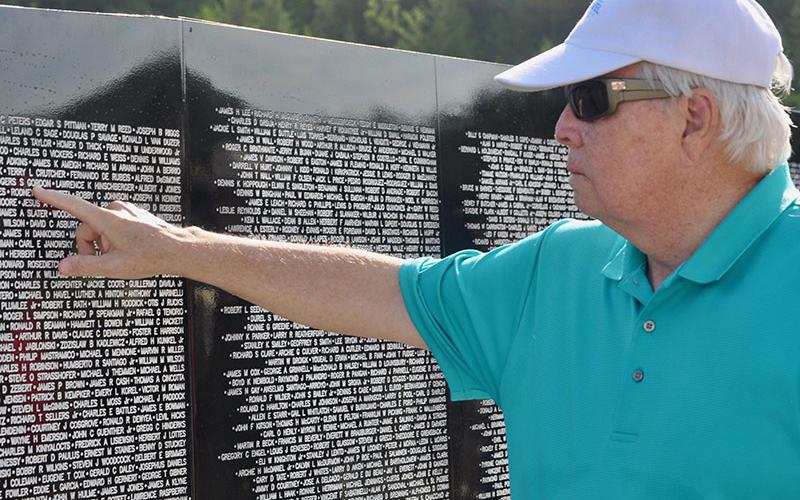 Jim Rozelle finds the names of fallen Vietnam War soldiers following the The Vietnam Traveling Memorial Wall memorial service.