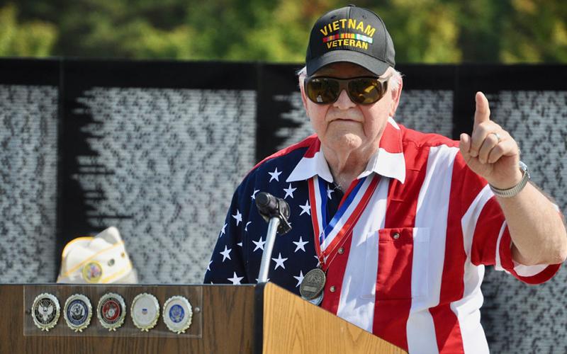 Vietnam War veteran George Nelson explains some of the history of the war to the crowd gathered for The Vietnam Traveling Memorial Wall memorial service Friday, October 4. The wall was on display in Blue Ridge from October 3 to 7.