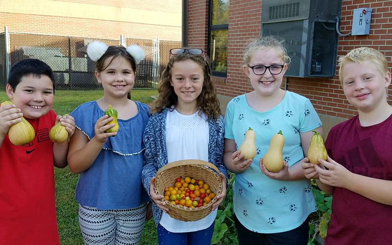 Fourth grade West Fannin Elementary School students recently harvested tomatos and squash to be used in dishes at Lit’l Pond Hospitality Group restaurants. Shown are, from left, Reed Chancey, Bea Painter, Abigail Gardner, Skylar Gazaway and Luke Sosebee.
