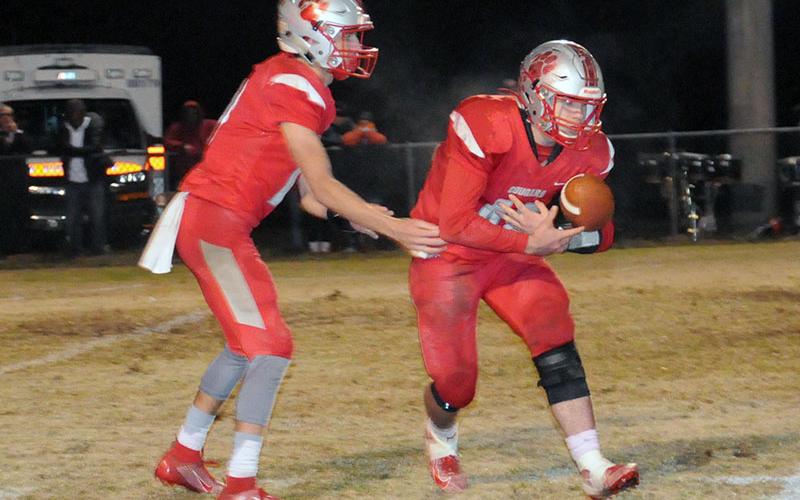 Copper Basin quarterback Bryson Grabowksi (13), hands the ball off to running back Chance Bailey (42) during Copper Basin’s game with South Pittsburg Friday, November 1.
