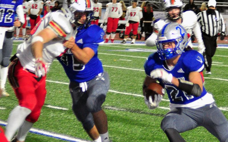 Senior Rebel Will Mosely (35) throws a block while senior Treylyn Owensby (21) gets the edge during the Rebels region game with the GAC Spartans Friday, November 8.