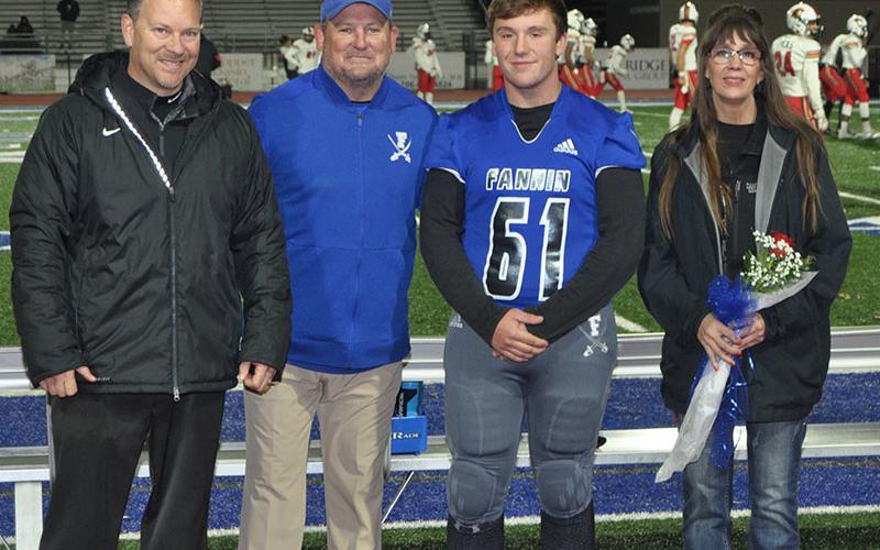 Fannin County High School honored the football seniors before the Rebels game against GAC Friday, November 8. Shown is senior Ethan Mann with head coach Chad Cheatham and mother Susie Mann.