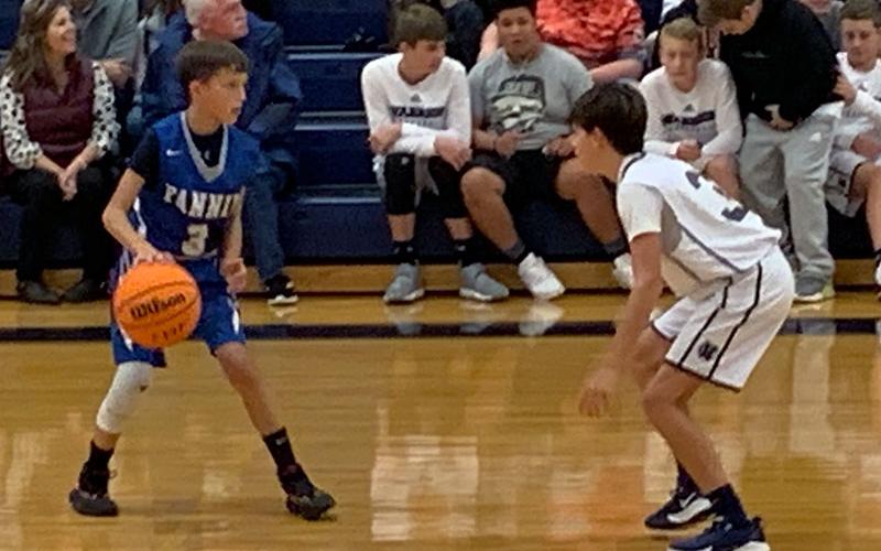 Seventh grader Matthew Ponton handles the defensive pressure from White county during the Rebels basketball game Thursday, November 7.