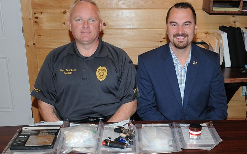 McCaysville Police Chief Michael Earley, right, and Detective Captain Billy Brackett are shown with 87 and a half grams of methamphetamine and assorted drug related objects confiscated during an arrest Thursday, October 31, at Mountain Lane Apartments.