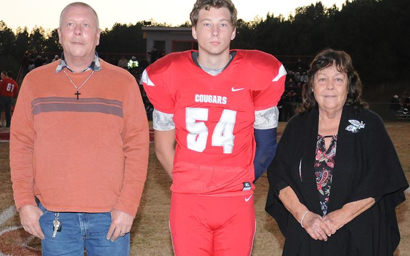 Senior Cougar Jimmy Madar was honored during senior night at Copper Basin Friday, November 1. Madar is shown with Steve Mann and Mary Trembling.