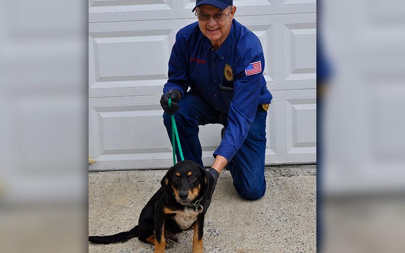 Animal Control Officer Pat Patterson kneels with this male black and tan mixed breed who volunteers have named Clarke. He will be staying at Animal Control until adopted. Clarke boasts a shiny coat and dark brown eyes. View him under Animal Control number 341-19.