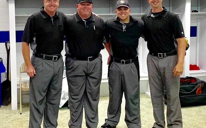 Tim Towe smiles among fellow umpires after working the 2019 Kingsport Regional Final. Shown, from left, are Kerry Bryan, Aaron Hill, Towe and Wes Jones.