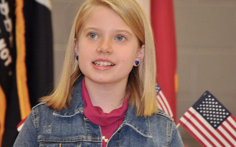 Blue Ridge Elementary School student Laurel Minear sang the first verse of “God Bless the USA” at the school’s Veterans Day Ceremony Friday, November 8.