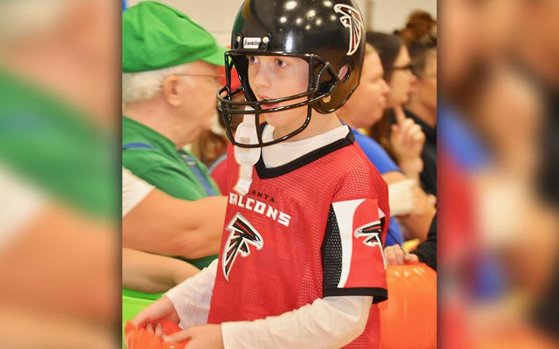 Atlanta Falcon Cash Rittenberry searches for candy at East Fannin Elementary School’s Halloween event Thursday, October 31.