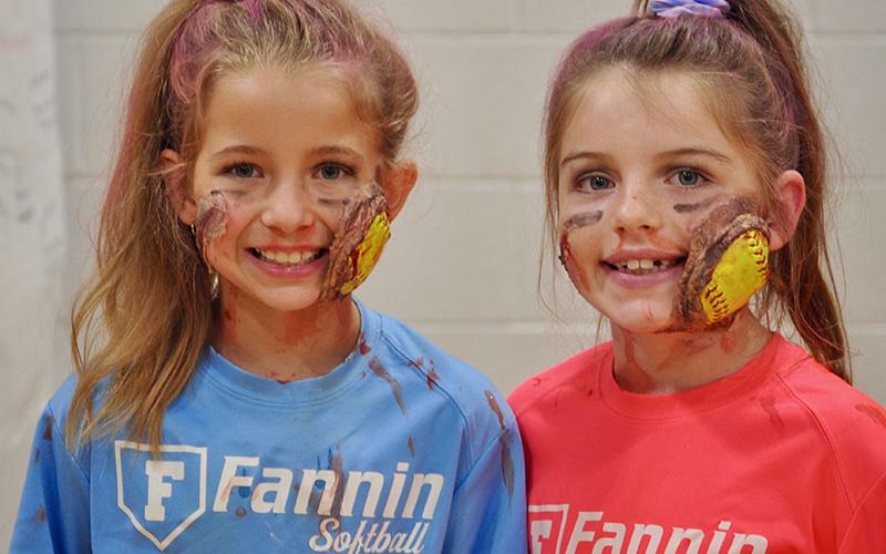 Braylee Davenport, left, and Toccoa Hampton display their grisly softball injuries at East Fannin Elementary School’s trick-or-treating event.