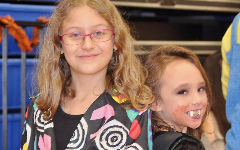 Brianna Prater, left, and Morgan Nelson trick or treat as Eleven from Stranger Things and a vampiress at East Fannin Elementary School’s Halloween event.