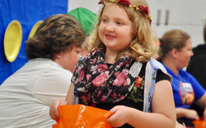 East Fannin Elementary School student River Ayers excitedly walks to get more candy at the school’s trick-or-treating event.