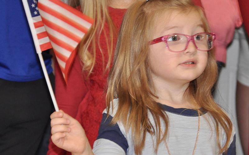 East Fannin Elementary School student Clara Stites excitedly waved the American Flag during the school’s veterans program.