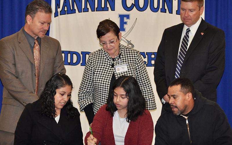 Fannin County Middle School student Estenfania Rosas-Leal signed her REACH scholar contract with her family Tuesday, November 12. Shown are, from left, front, Silvia Espinoza, Rosas-Leal and Ambrosio Rosas; back, Fannin County High School Principal Erik Cioffi, ESOL teacher Alejandra Mills and Superintendent Dr. Michael Gwatney.