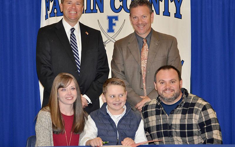 Fannin County Middle School student Silas Campbell signed his REACH scholar contract with his family Tuesday, November 12. Shown are, from left, front, Brooke Campbell, Silas Campbell and Nathan Campbell; back, Superintendent Dr. Michael Gwatney and Fannin County High School Principal Erik Cioffi.