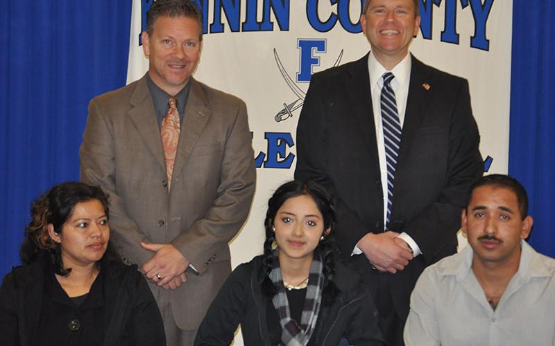 Fannin County Middle School student Brisa Lopez-Garcia signed her REACH scholar contract with her family Tuesday, November 12. Shown are, from left, front, Silvia Garcia, Lopez-Garcia and Martin Lopez; back, Fannin County High School Principal Erik Cioffi and Superintendent Dr. Michael Gwatney.