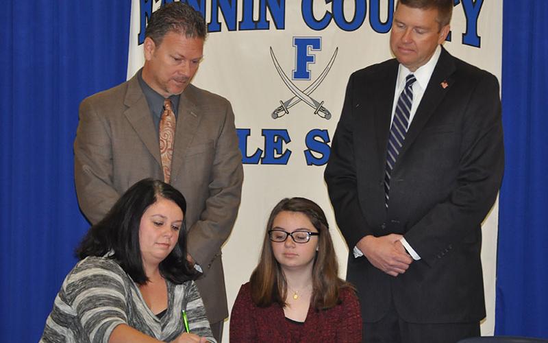 Fannin County Middle School student Emma Pittman signed her REACH scholar contract November 12. Shown are, from left, front, Brandi Pettus and Pittman; back, Fannin County High School Principal Erik Cioffi and Superintendent Dr. Michael Gwatney.