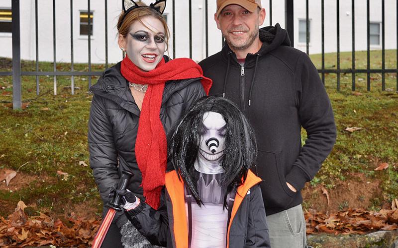 The rain didn’t stop people from trick-or-treating at the Blue Ridge Safe Zone event. Shown are, from left, Jessica Parris, Shawn Parris and Bryan Denahee.