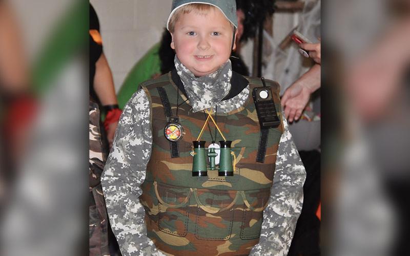 Army soldier, Will Henderson, finds candy at West Fannin Elementary School’s trick-or-treating event.