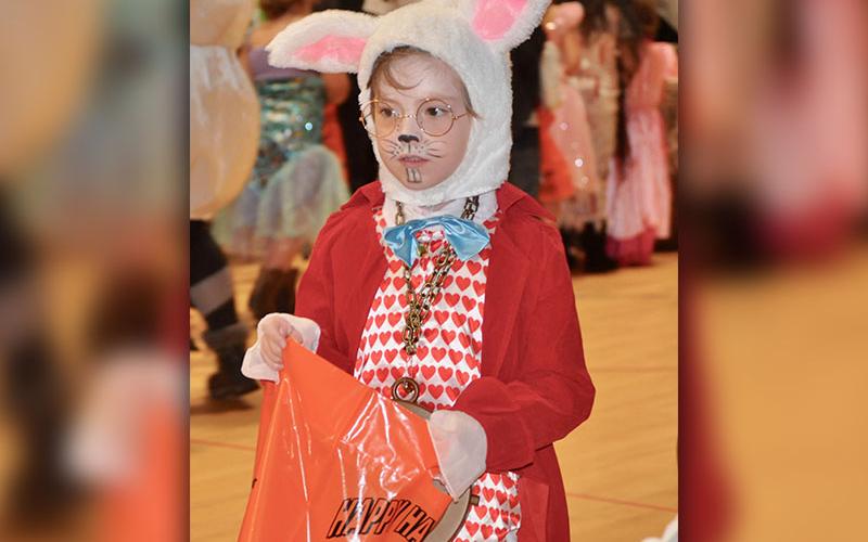 West Fannin Elementary School student River Ensley is disguised as the White Rabbit as she collects candy Halloween Day.