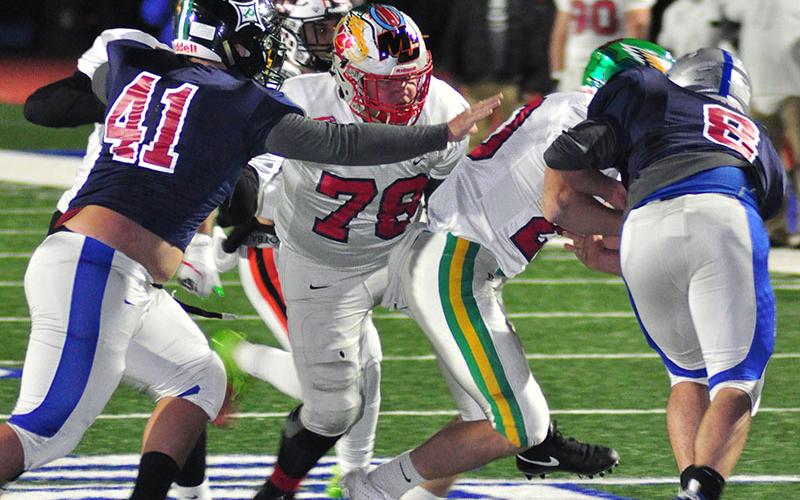 Copper Basin Cougar Isaac Leslie blocks for the ball carrier during FCA’s Border War Thursday, December 19.