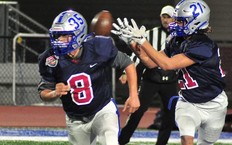 Fannin Rebel Will Mosley (8) leads the way for Rebel runningback Treylyn Owensby (21) during FCA’s Border War game at Fannin County High School Thursday, December 19.