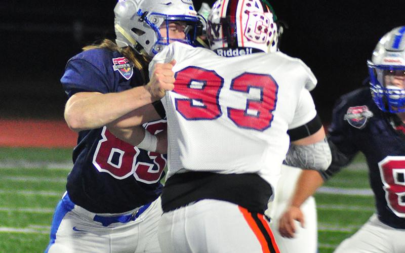 Fannin Rebel Jackson Weeks protects the quarterback during the Fellowship of Christian Athletes Border War at Fannin County High School Thursday, December 19.