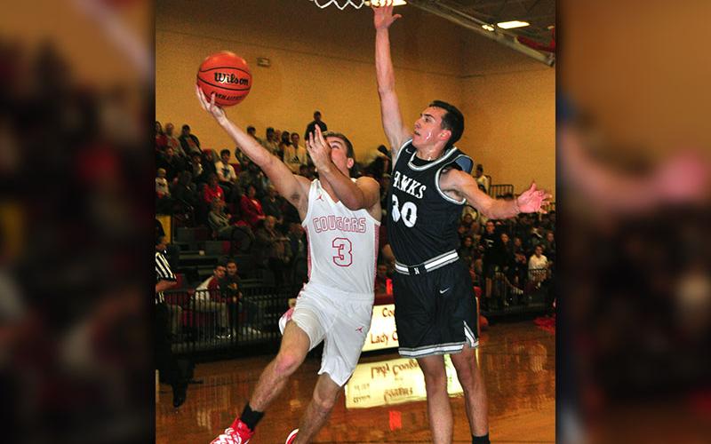 Copper Basin senior Chase Mickens fights through contact for a layup in recent action for the Cougars.