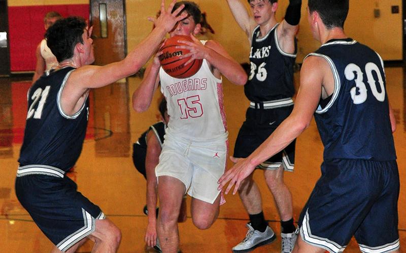 Copper Basin Cougar Tim Jabaley fights his way to the rim in recent action for the Cougars. Copper Basin beat Sale Creek to start 1-0 in district play.