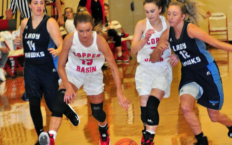 Lady Cougars Riley Smith (15) and Emily Hemming (33) fight for a loose ball in recent action for Copper Basin.