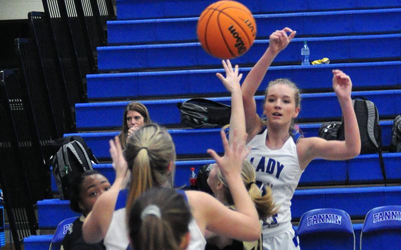 Lady Rebel Saidee Collins (11) passes the ball to Olivia Sisson (44) for two points during the Lady Rebels region win over the Lady Vikings Tuesday, December 17.