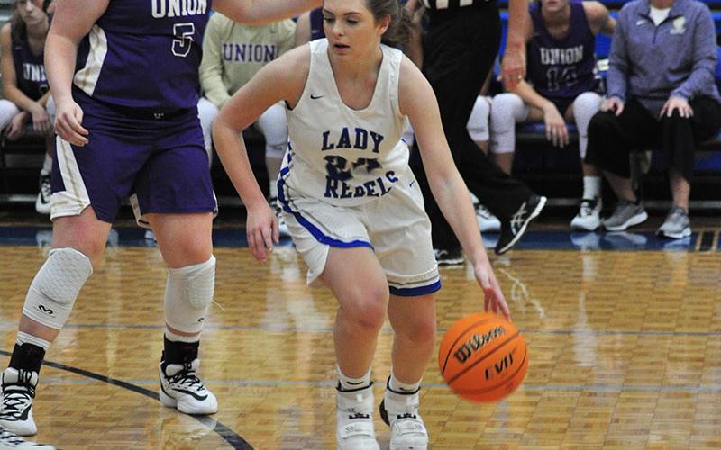 Lady Rebel Abby Ledford dribbles to the left side of the court to run a play during the Lady Rebels 52-47 win over the Union County Lady Panthers Saturday, December 7.