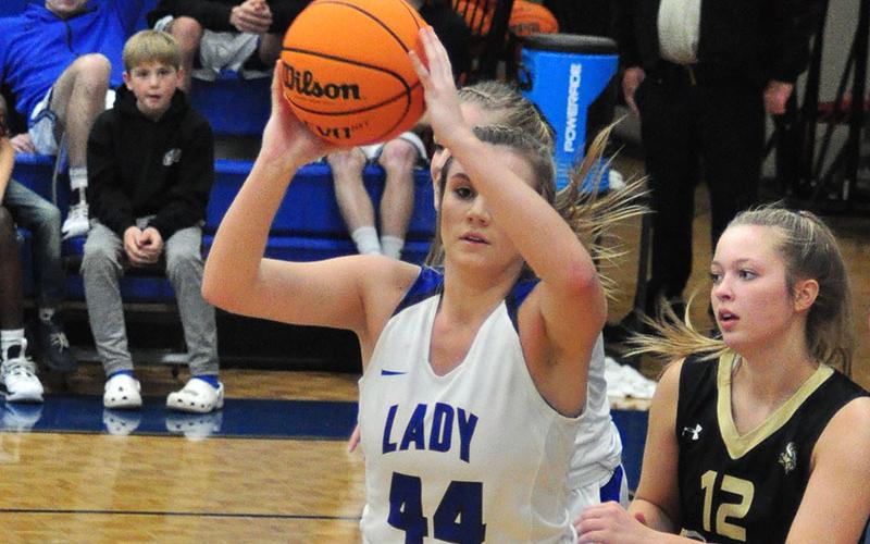 Lady Rebel Olivia Sisson passes the ball out of the paint in recent action for the Lady Rebels basketball team.