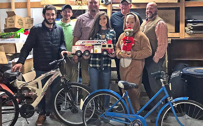 Polk County Executive Robby Hatcher and representatives of C&amp;B Auction and Deli are shown with some of the toys donated for Polk County children. Shown are, from left, Rugby Bunch, Timothy Trulove, Tommy Bunch, Hayley Stephenson, Fred Esch, Macey Bunch and Hatcher.