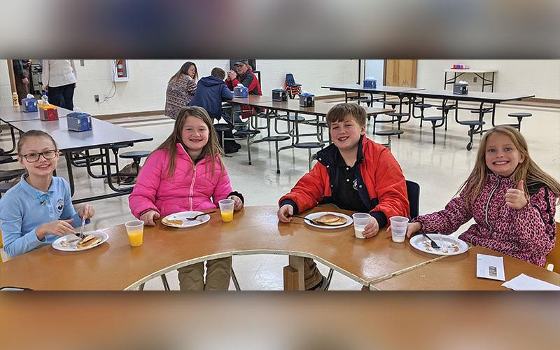 Mountain Area Christian students give a thumbs up to adoption and delicious pancakes during a breakfast fundraiser at the school December 12. School administrators Steve ad Nikki Shamblin are adopting a 14-year-old girl named Elizabeth. She is currently living in an orphanage in Colombia. Shown are, from left, Shelby Roesch, Madilyn Kerley, Elijah Kerley and Elizabeth Nave.